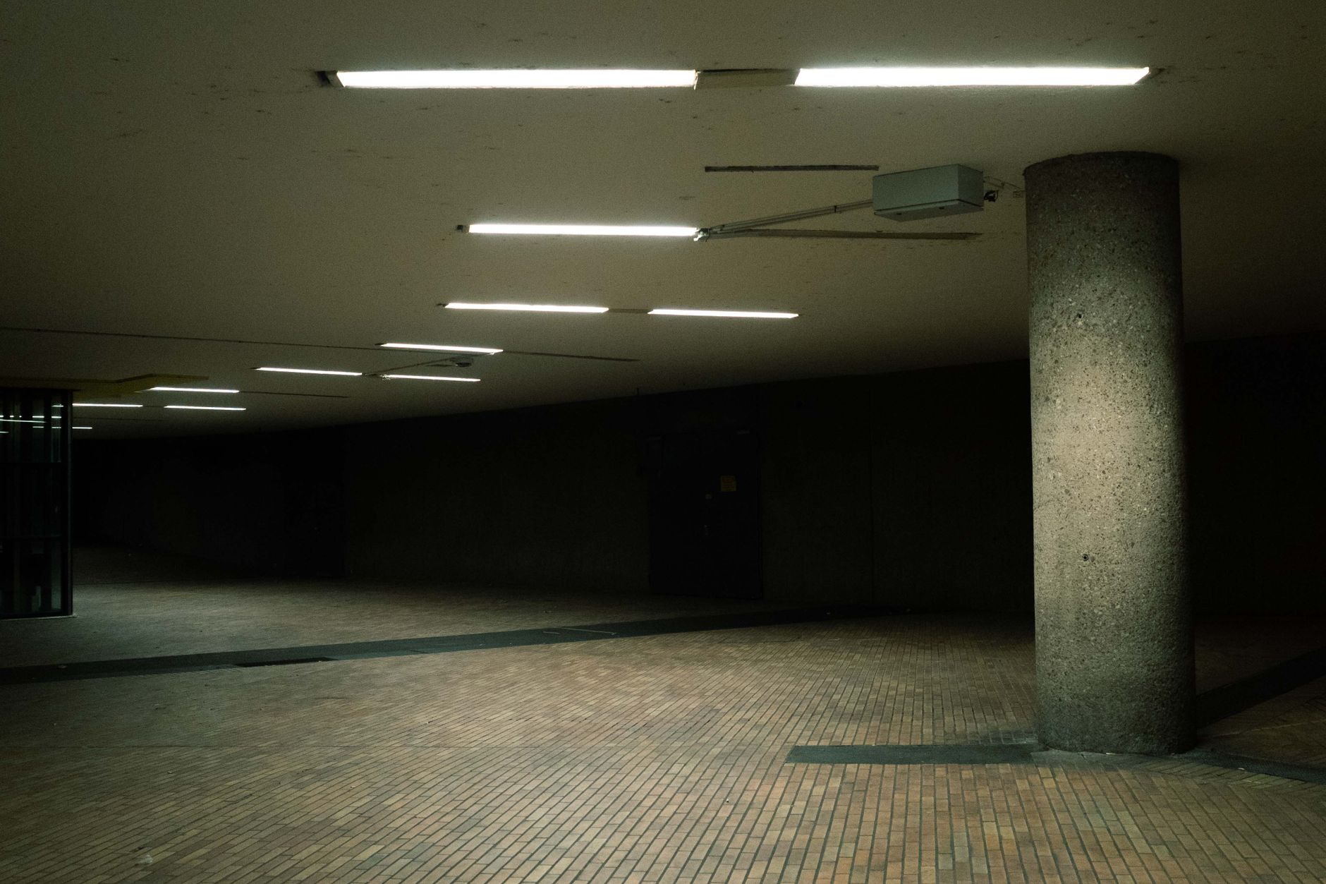 Dim underground parking area with a concrete ceiling